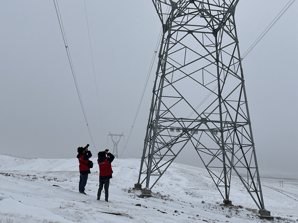 青海送變電玉樹運(yùn)檢分部運(yùn)維人員趙文龍、謝林明在330千伏唐瑪線593號(hào)塔位對(duì)鐵塔進(jìn)行覆冰情況排查。李增成攝